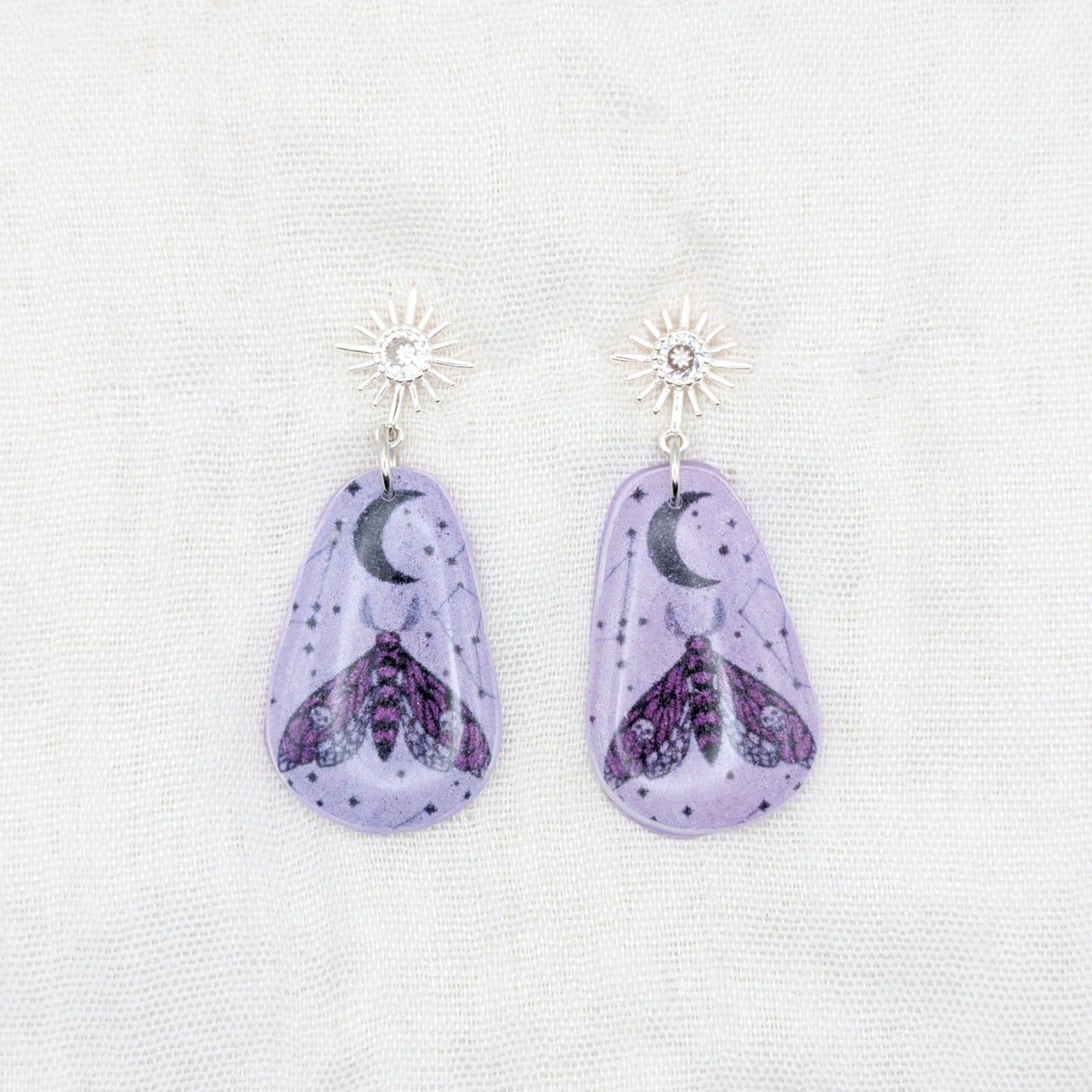 Lavender moth rounded teardrop earrings with silver cubic zirconia starburst posts