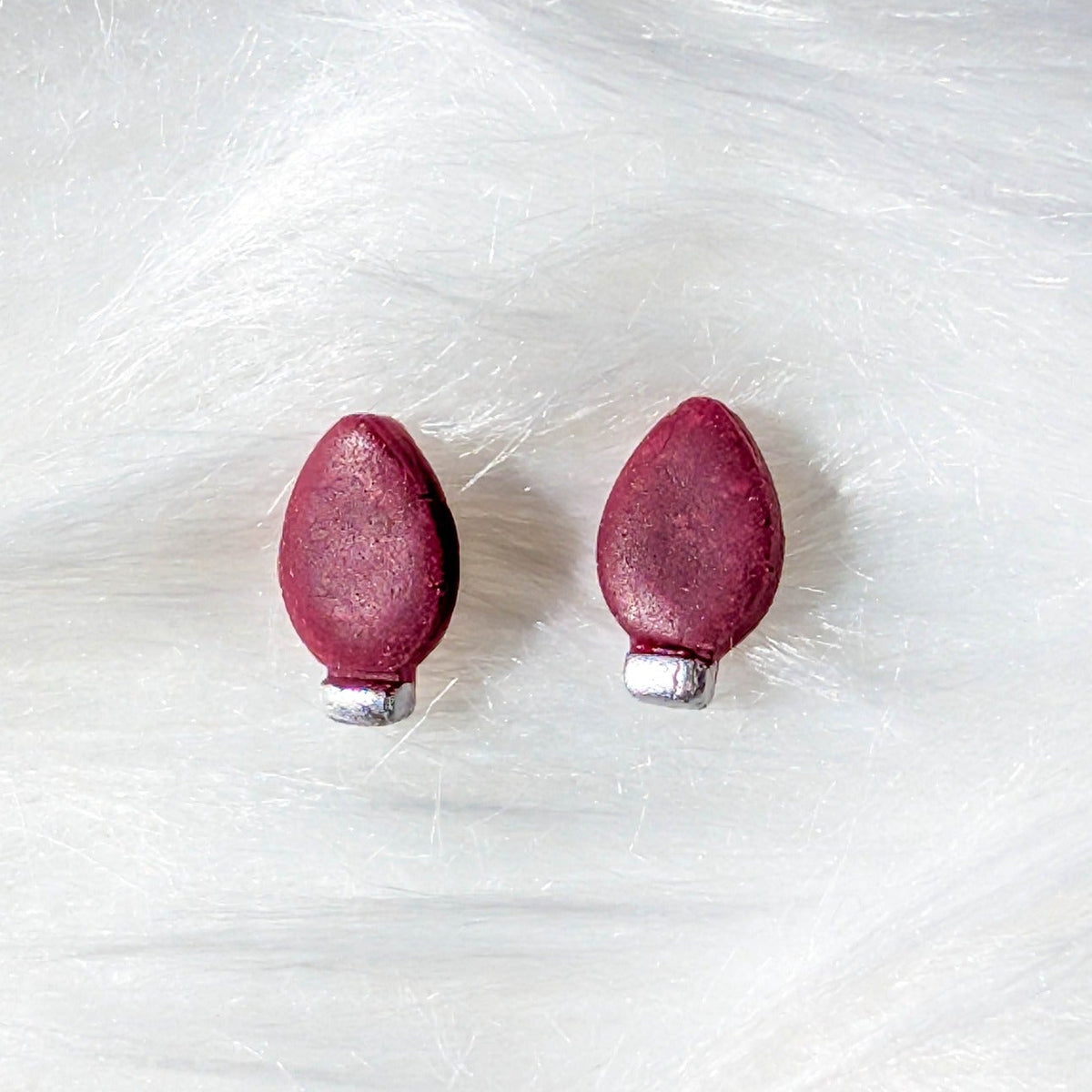 Red Christmas light bulb stud earrings with a silver metallic finish