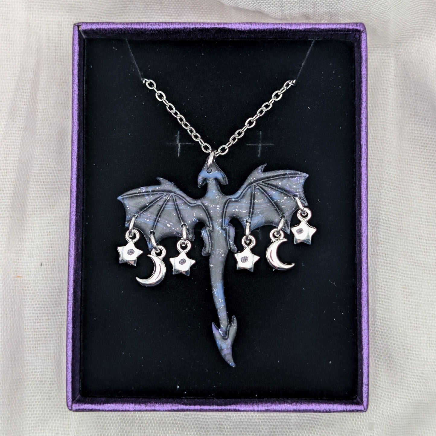 Marbled dragon necklace with silver chain and a garland of moon and star charms