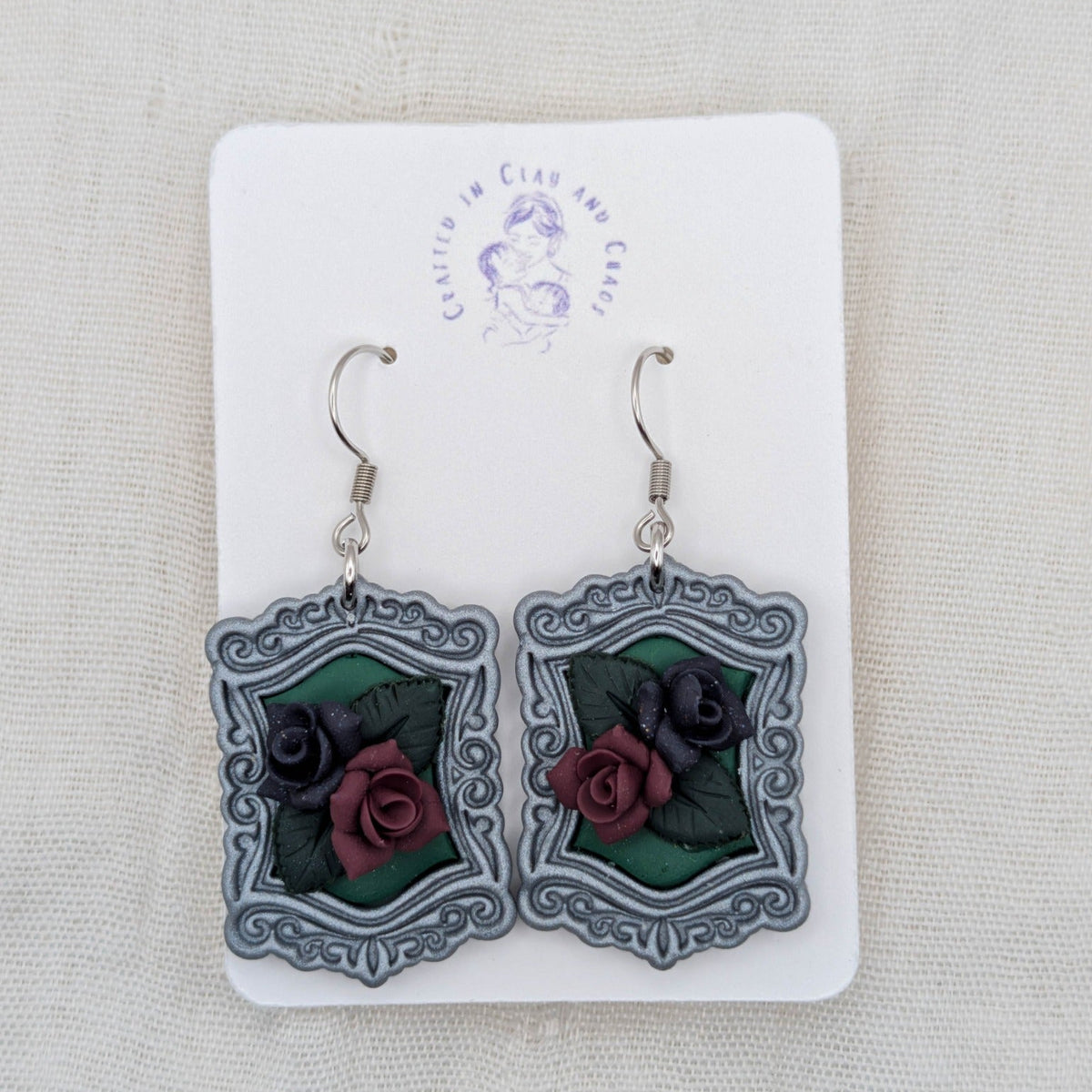 Silver vintage frame earrings with green background, sculpted burgundy and dark purple roses, and surgical-grade stainless steel hooks