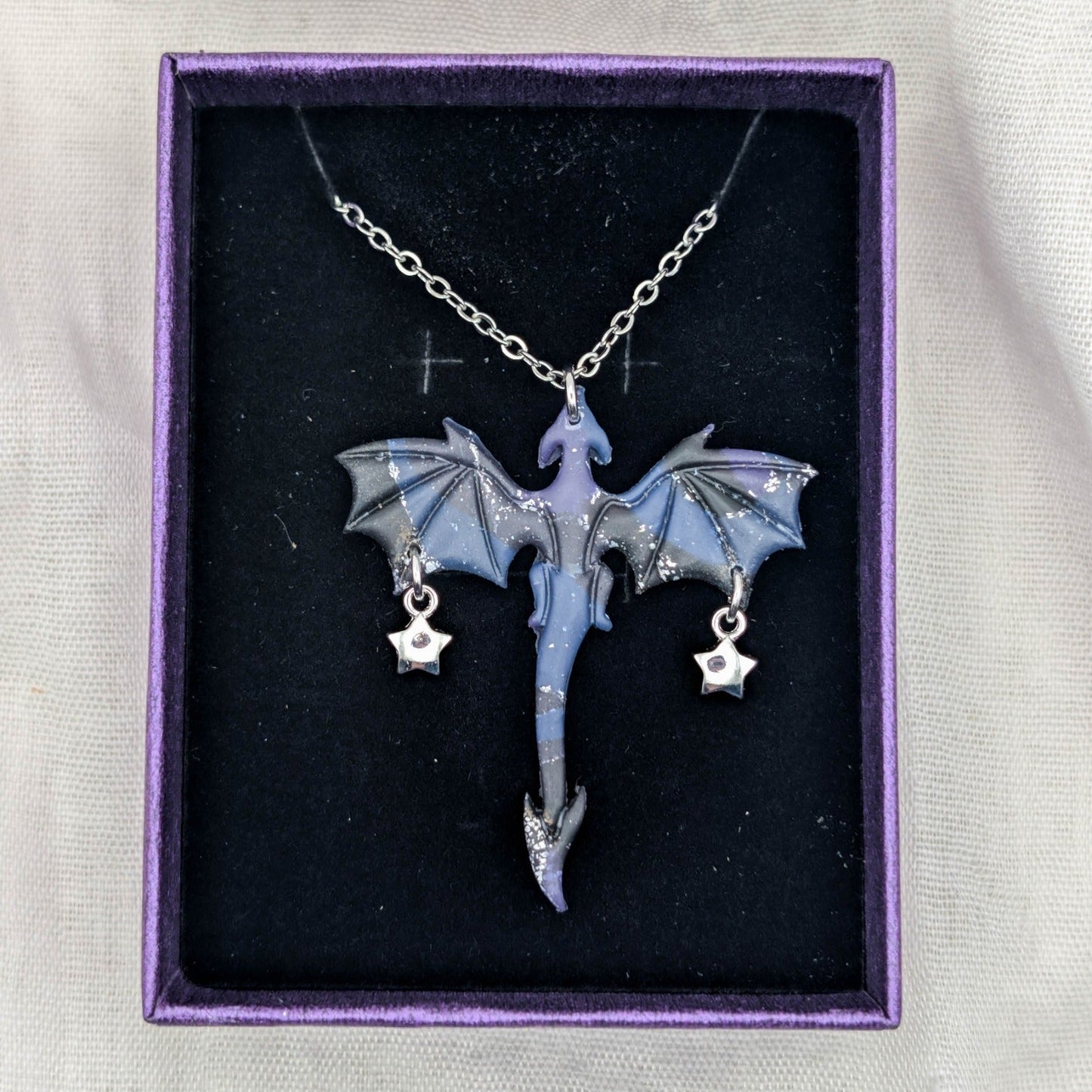 Purple blue and black marbled dragon necklace with silver chain and two petite star charms