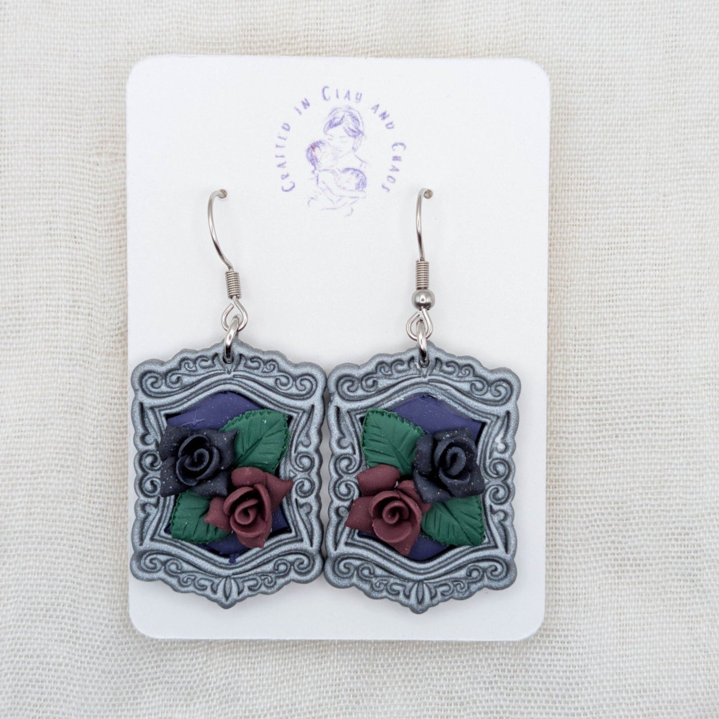 Silver vintage frame earrings with purple background, sculpted burgundy and dark purple roses, and surgical-grade stainless steel hooks