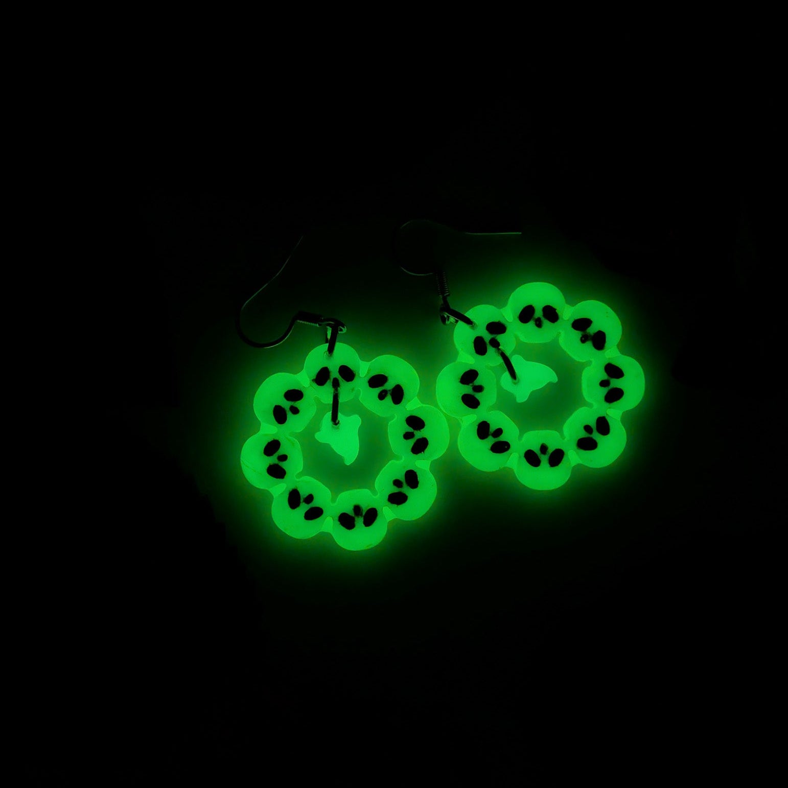 Skull wreath ghost earrings glowing vivid green in the dark