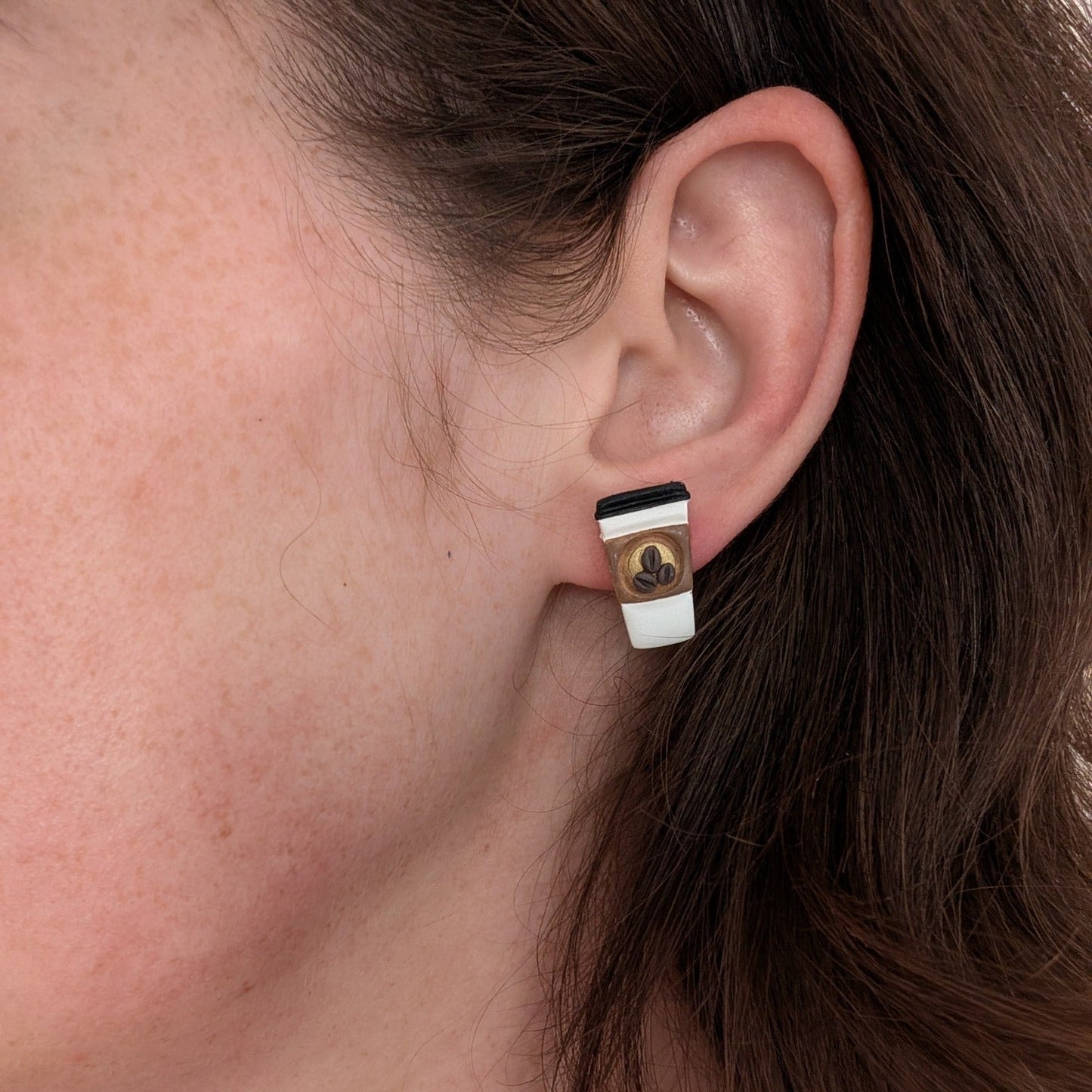 Takeout coffee cup stud earring worn on ear