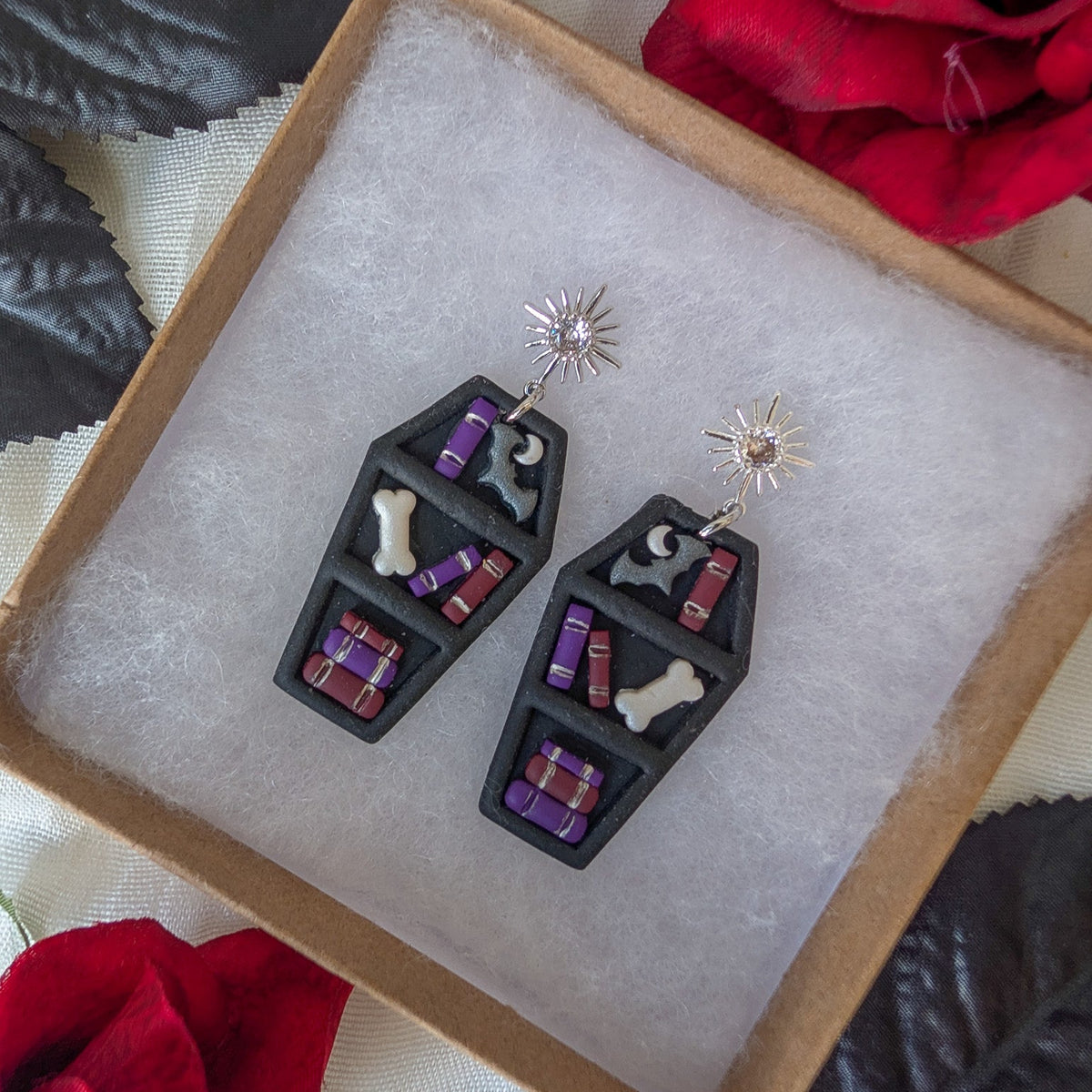Vampire romance bookcase earrings styled with red roses and black leaves