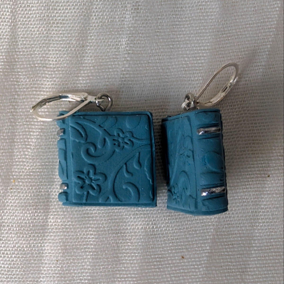 Embossed Vintage Blue book earrings with floral details, silver accents, and silver findings