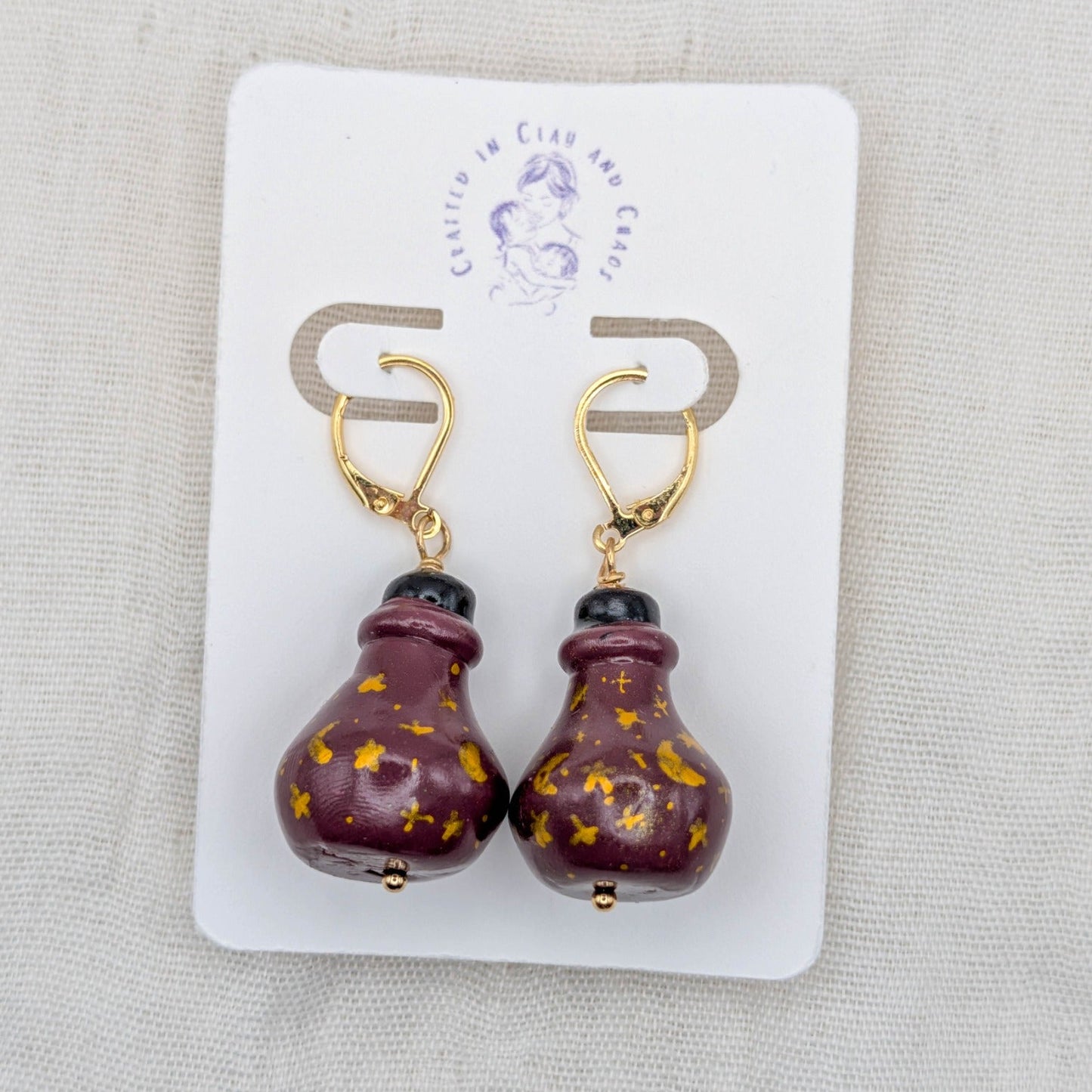Wine red handmade 3D potion bottle earrings with hand-drawn gold celestial symbols and gold-plated leverbacks