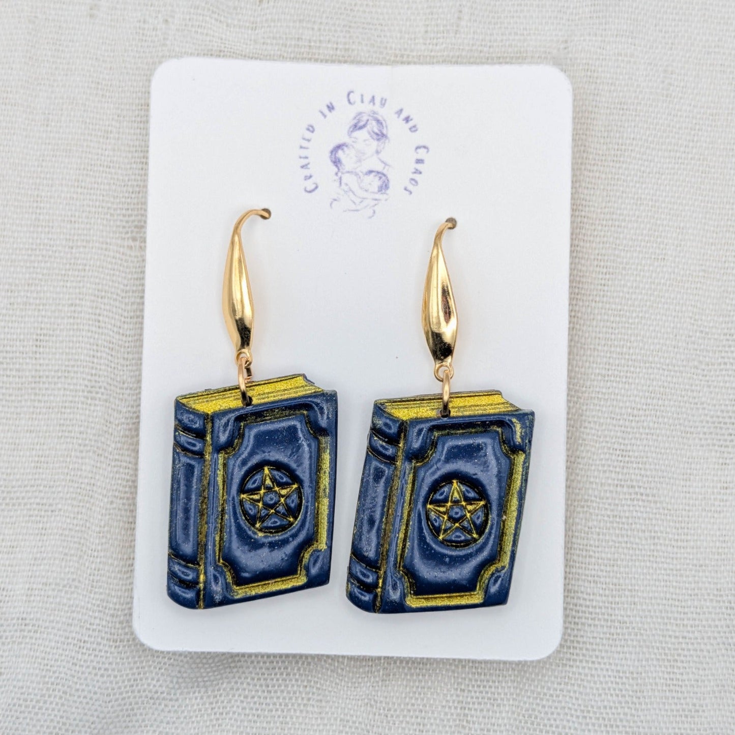 Handmade midnight blue witchy spellbook earrings with gold hooks